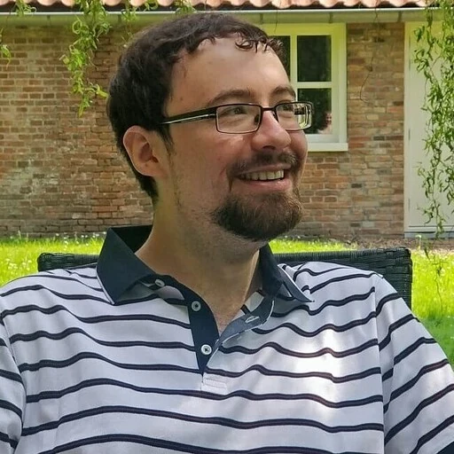 Michael Haddon, smiling, in a garden
